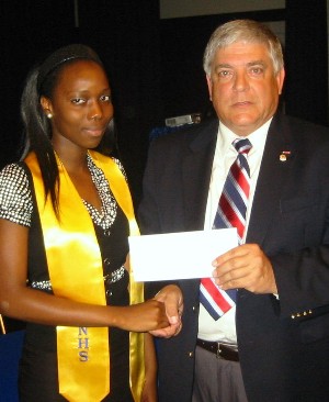 Omolara Ojewole (l) receives a $1,000 scholarship from Budura in May.